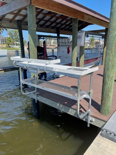 Fish Cleaning Table with upper shelf, Sink, hose holder, drawer, knife rack, & cup holder. Backside Mounted View