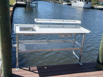 Fish Cleaning Table with upper shelf, Sink, hose holder, drawer, knife rack, & cup holder. Front Side View